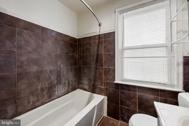 a bathroom with a bathtub and window