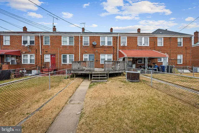 a view of a building with swimming pool and sitting area