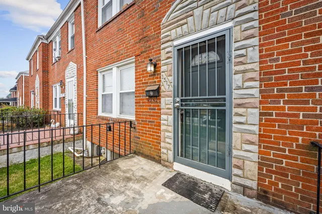a view of a brick house with large windows