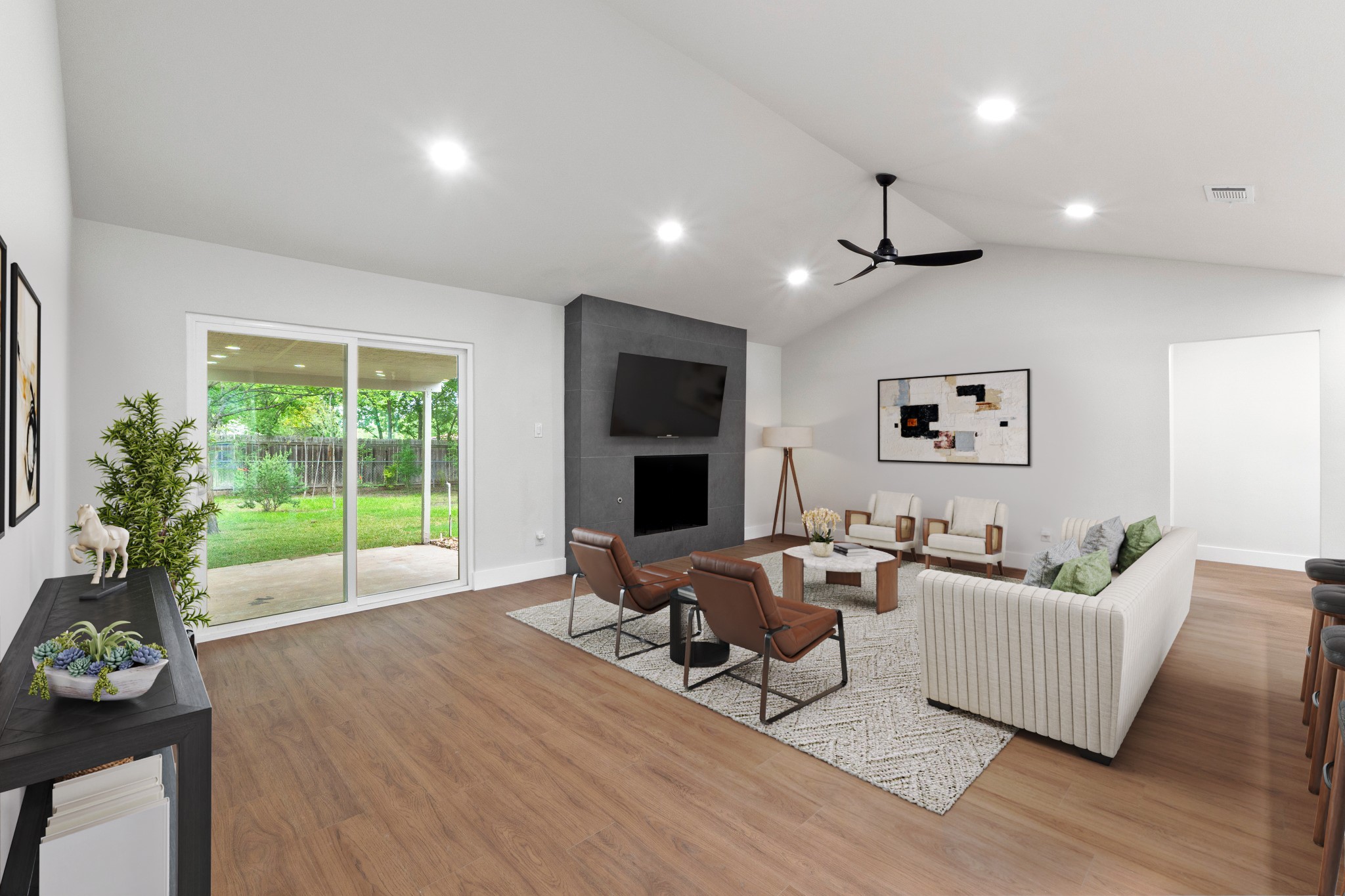 1608 Springer Lane Austin, TX 78758 - Photo 14 of 35 Open-concept living space featuring wood-finish flooring, a vaulted ceiling with recessed lighting, and a modern ceiling fan