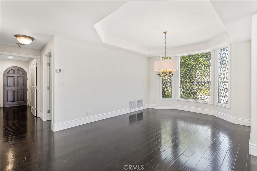 1608 Smiley Ridge Redlands, CA 92373 - Photo 16 of 84 an empty room with wooden floor chandelier fan and windows