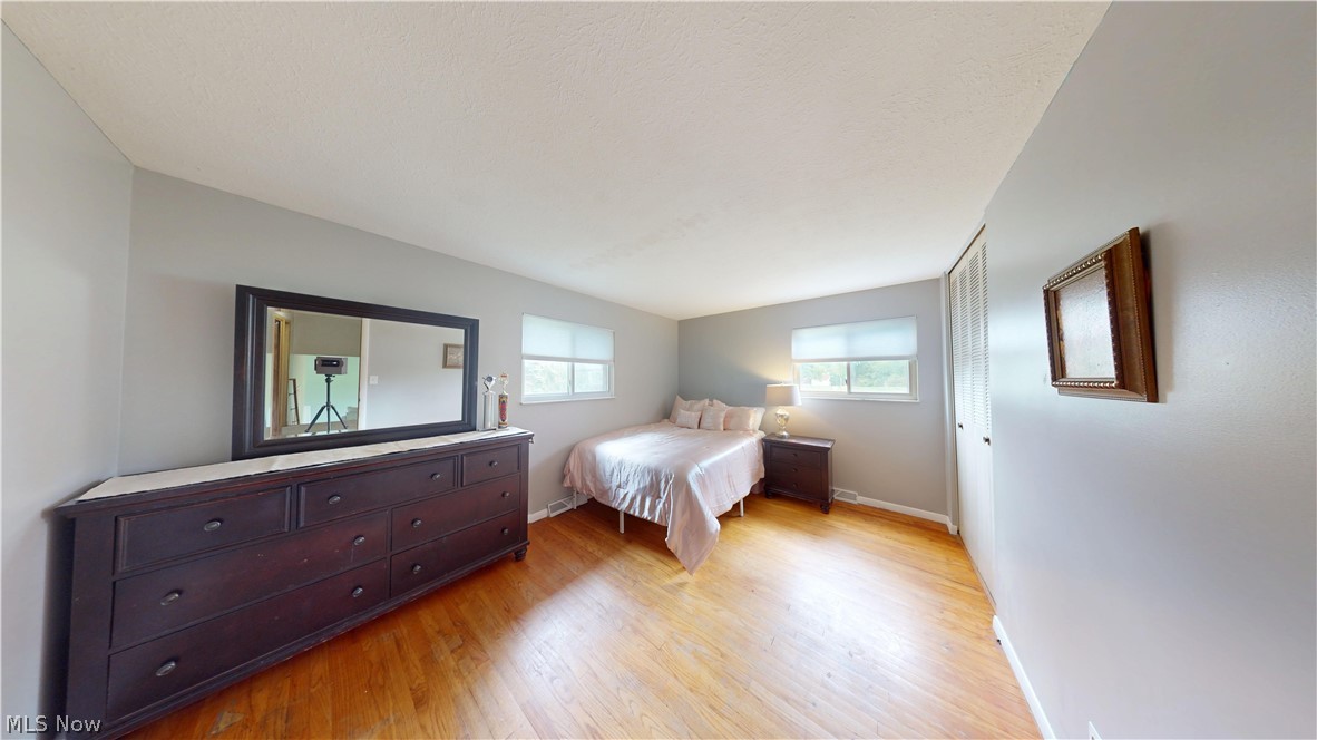 9260 Avery Road Broadview Heights, OH 44147 - Photo 19 of 43 Wood-finish flooring with light gray walls, white trim, and white window blinds