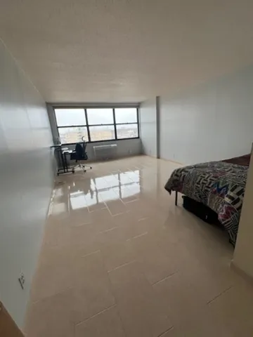 a bedroom with furniture and window