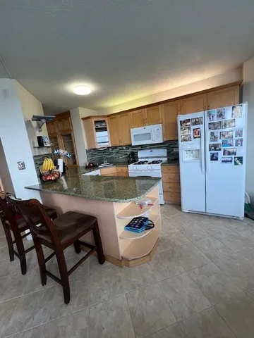 a view of kitchen and dining room with cabinets
