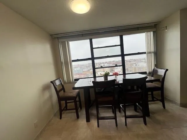 a view of a dining room with furniture and a window