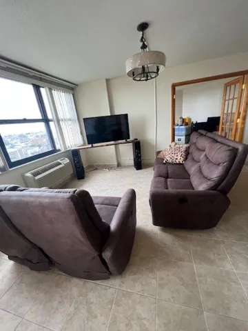 a living room with furniture and a large window
