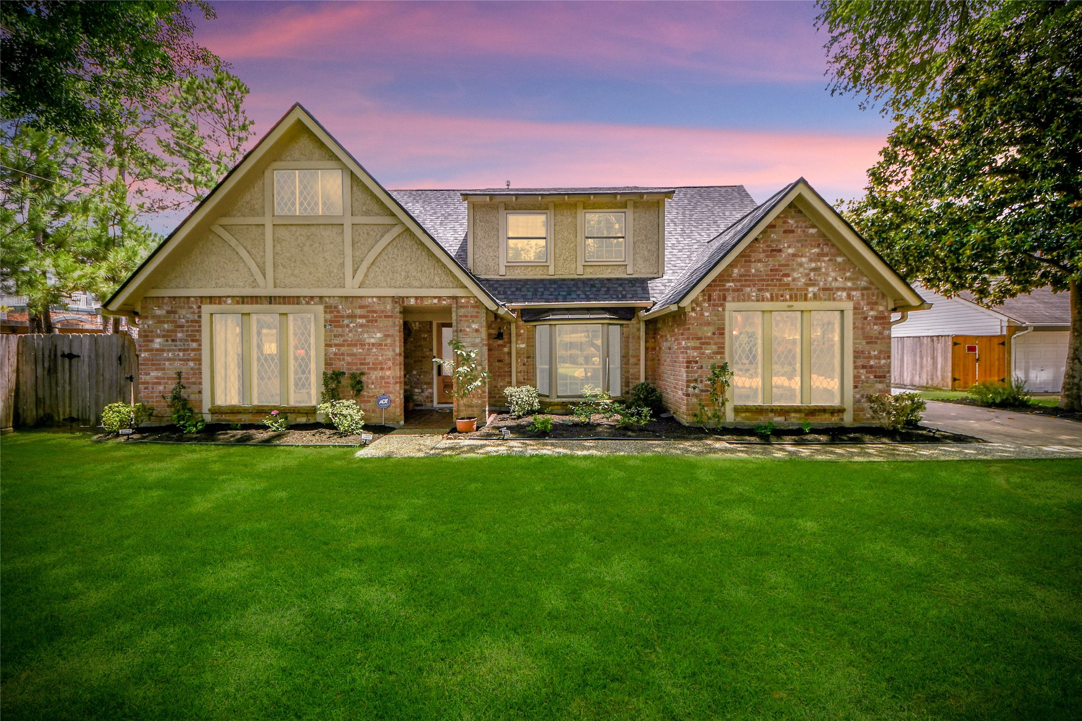 a front view of a house with a garden and porch