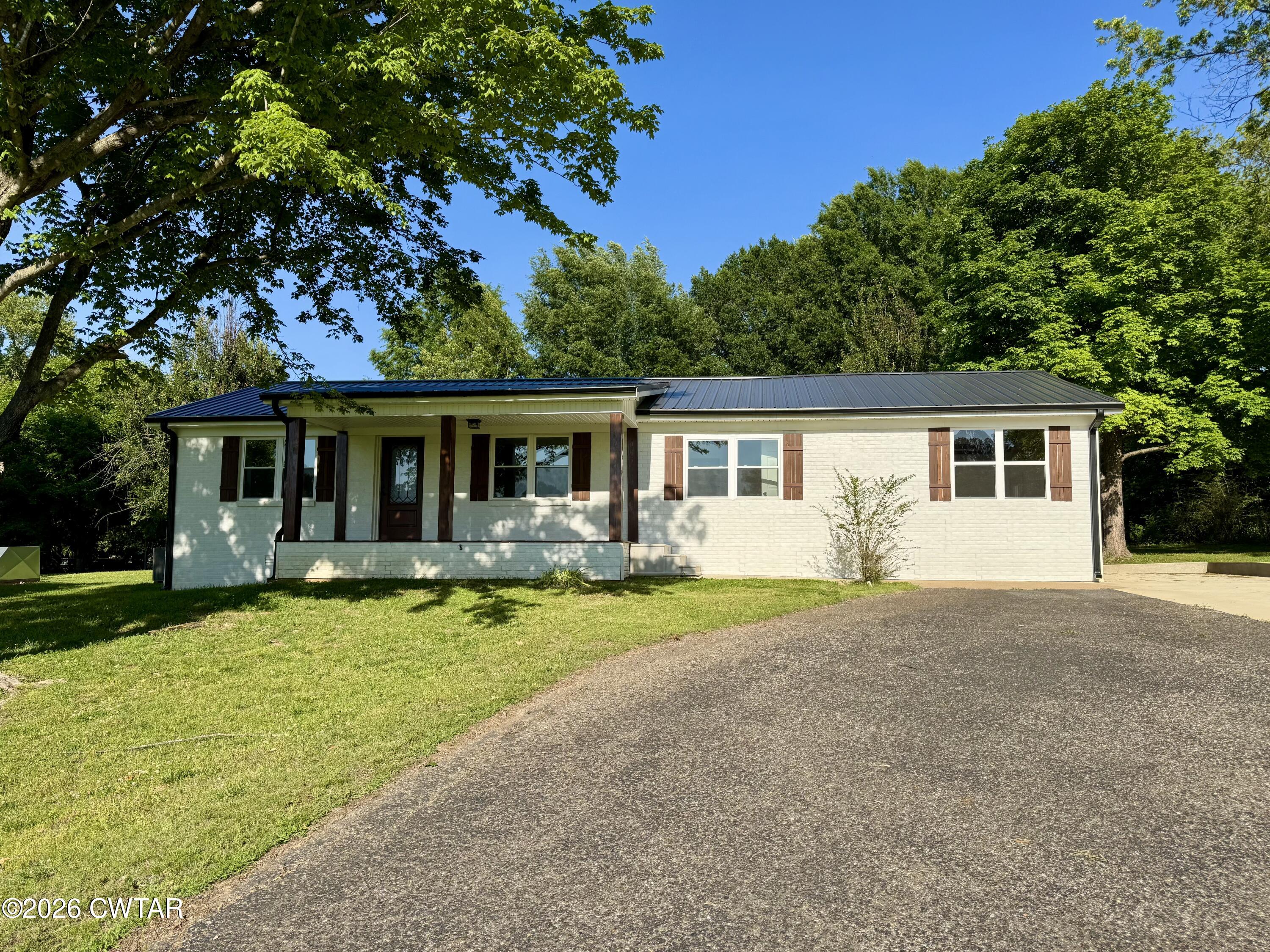 98 Reagan Road Dyersburg, TN 38024 - Photo 1 of 31 front view of a house with swimming pool and porch with green space