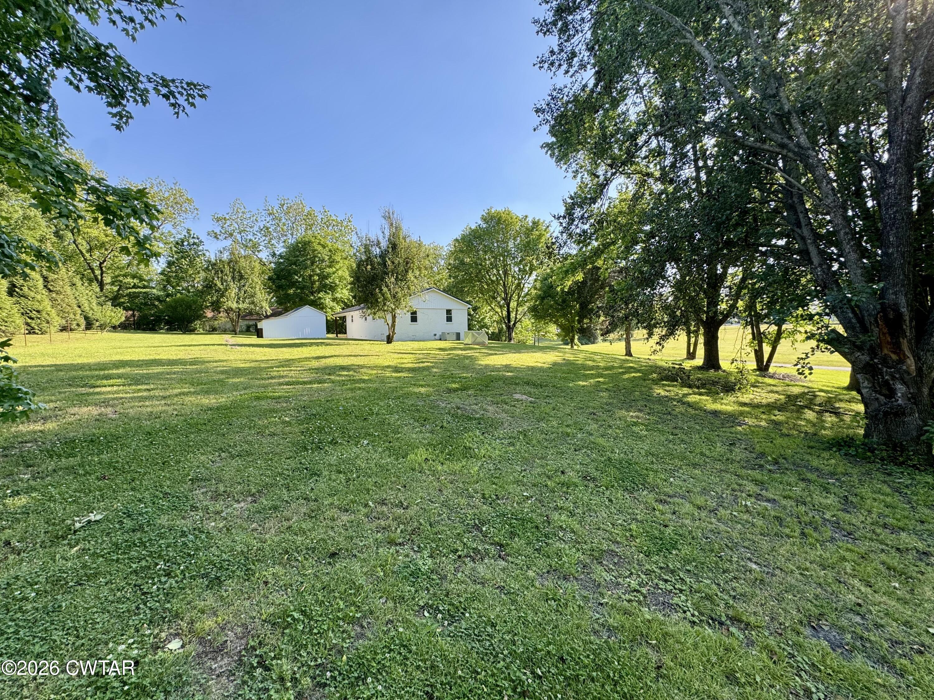 98 Reagan Road Dyersburg, TN 38024 - Photo 13 of 31 a view of field with trees in the background