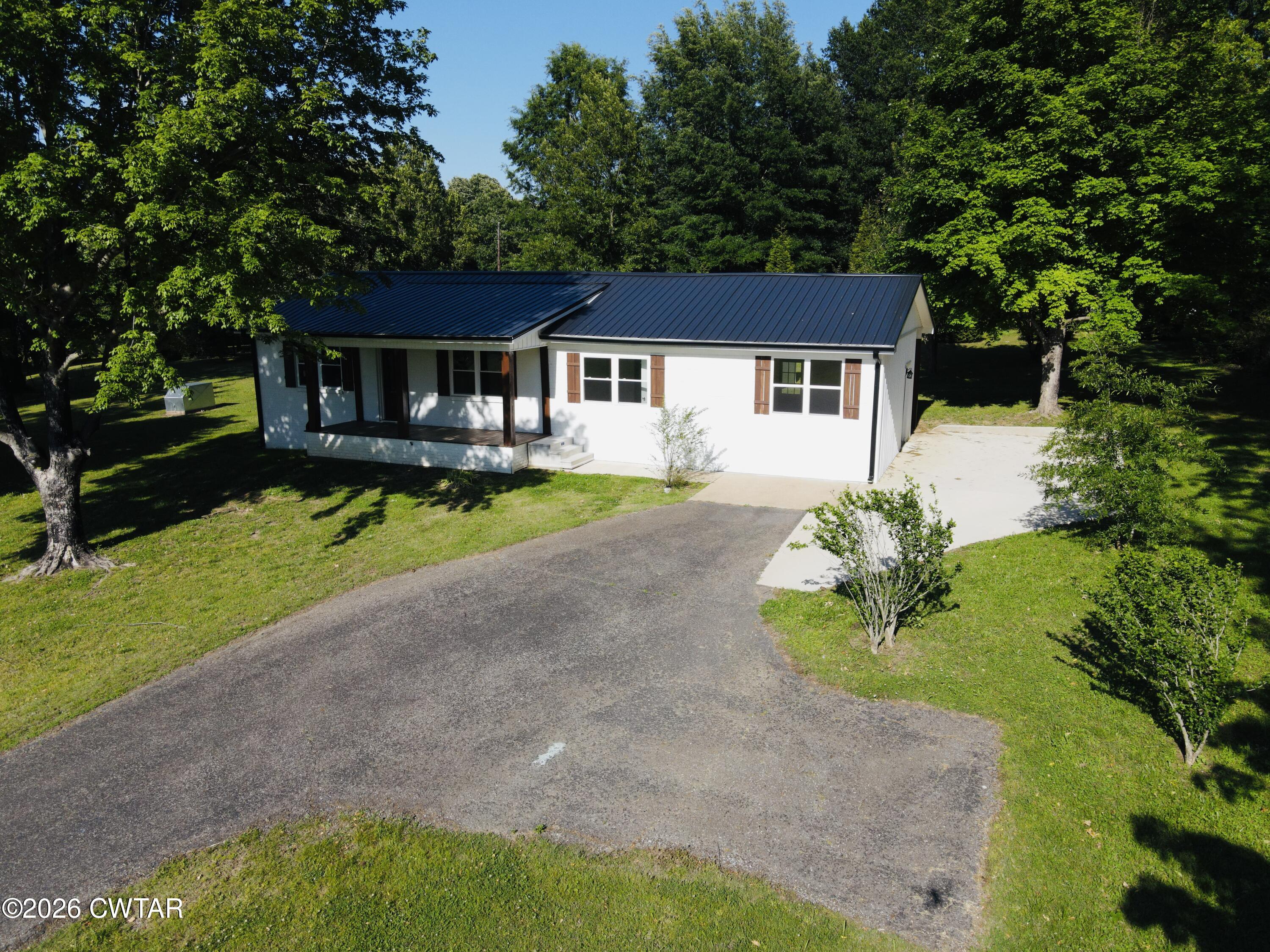 98 Reagan Road Dyersburg, TN 38024 - Photo 15 of 31 a front view of a house with a garden and yard