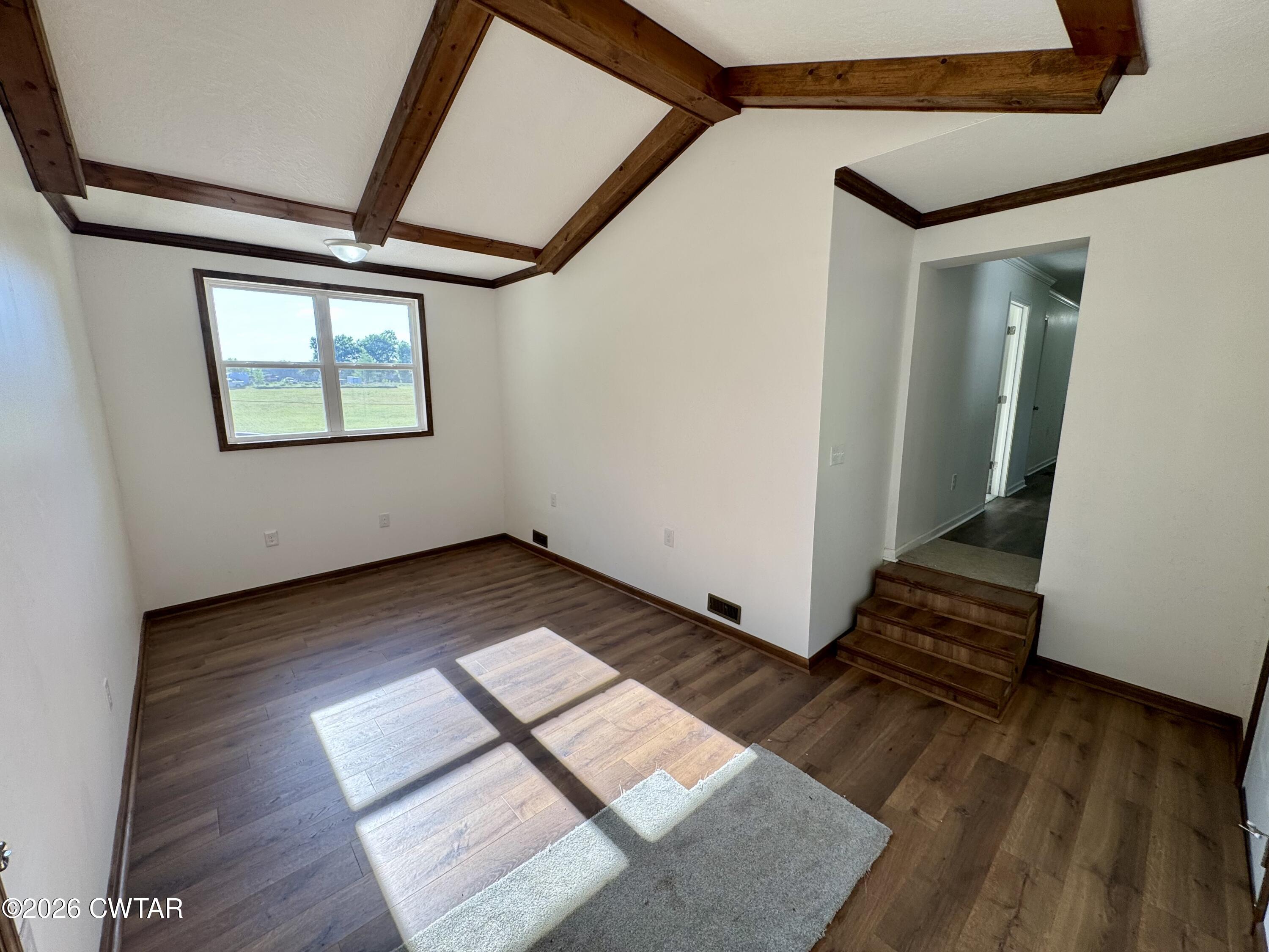 98 Reagan Road Dyersburg, TN 38024 - Photo 20 of 31 a view of an empty room with wooden floor and a window