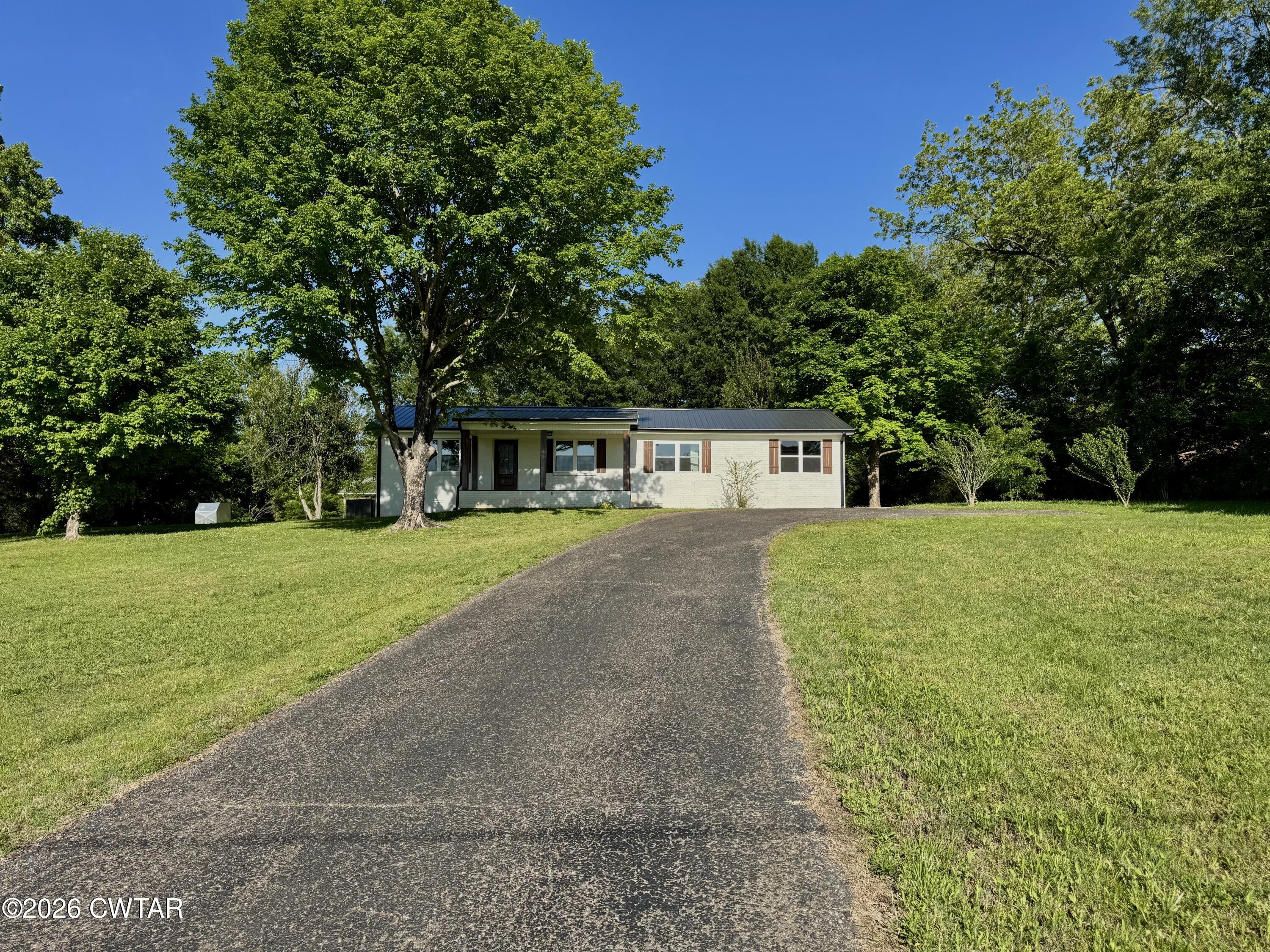 98 Reagan Road Dyersburg, TN 38024 - Photo 2 of 31 a front view of a house with yard and green space