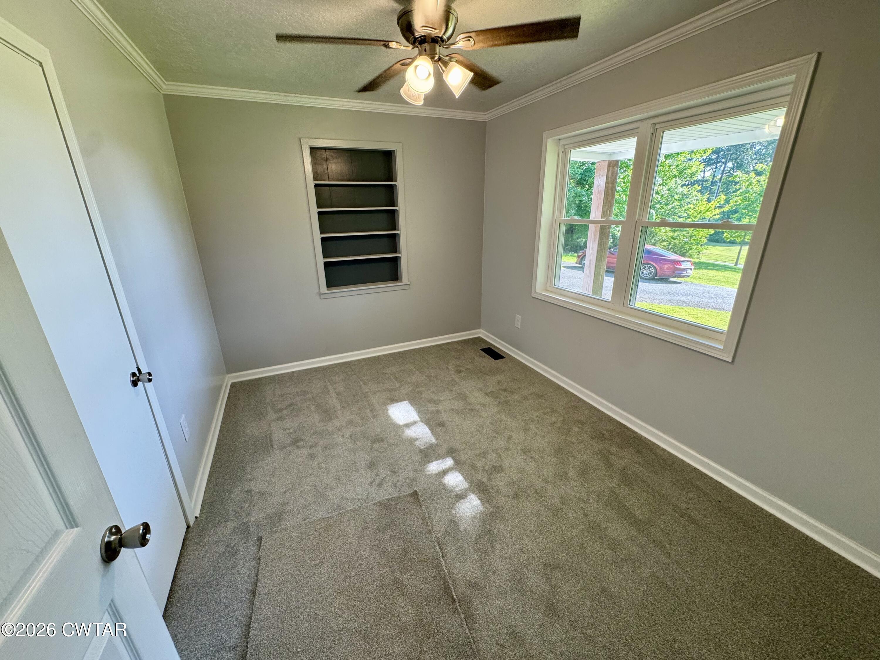 98 Reagan Road Dyersburg, TN 38024 - Photo 30 of 31 en empty room with windows and ceiling fan