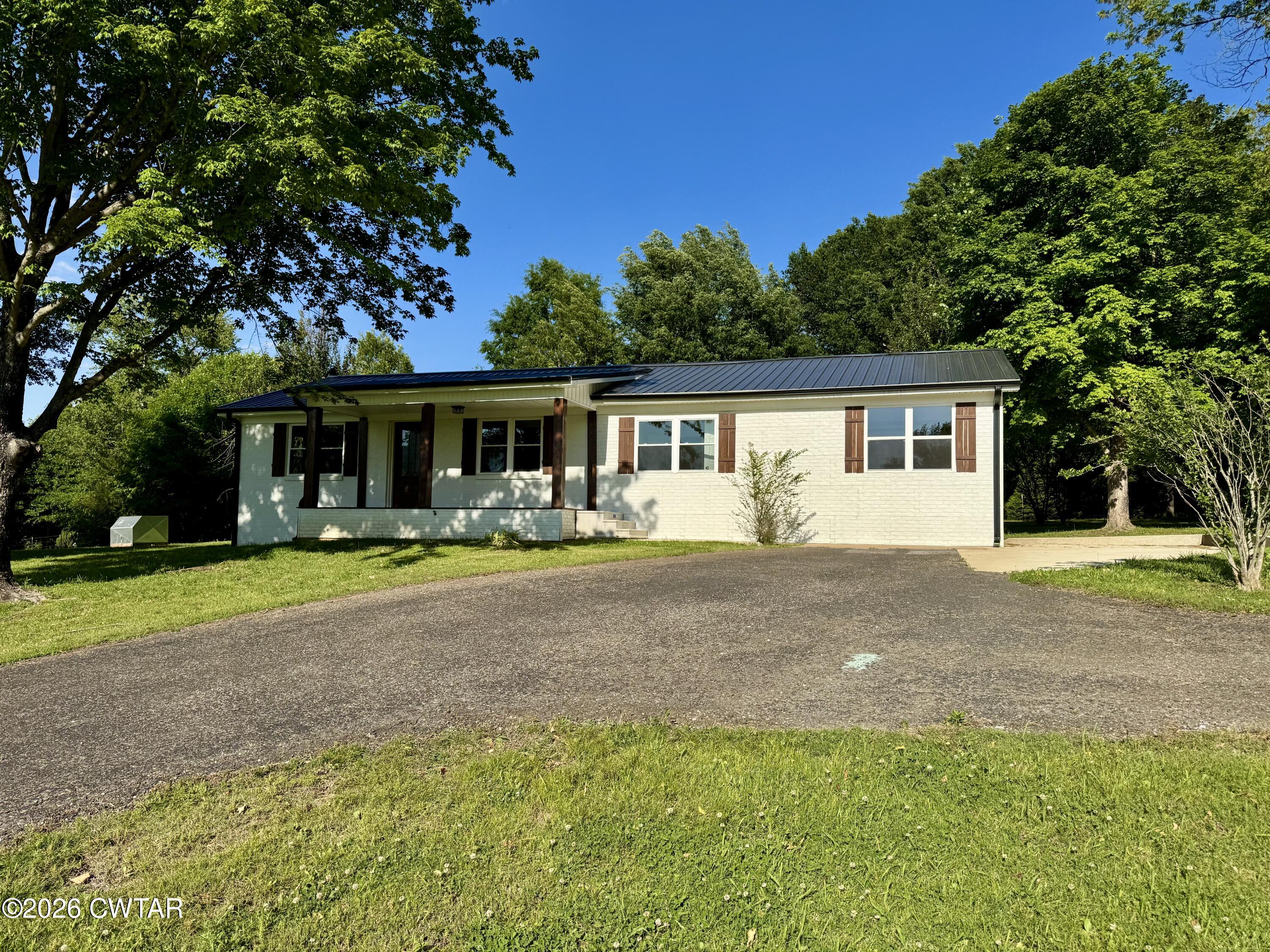 98 Reagan Road Dyersburg, TN 38024 - Photo 4 of 31 a view of a house with backyard and a swimming pool