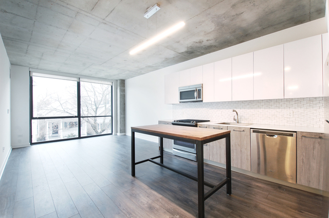 Undisclosed Address Chicago, IL 60657 - Photo 11 of 17 a kitchen with stainless steel appliances granite countertop a stove a sink and a refrigerator with wooden floors