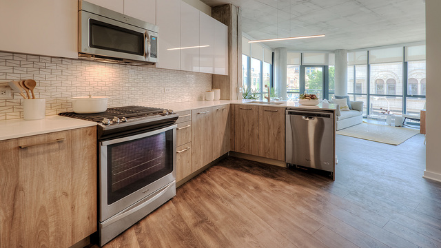Undisclosed Address Chicago, IL 60657 - Photo 9 of 17 a kitchen with stainless steel appliances a stove a sink and a microwave