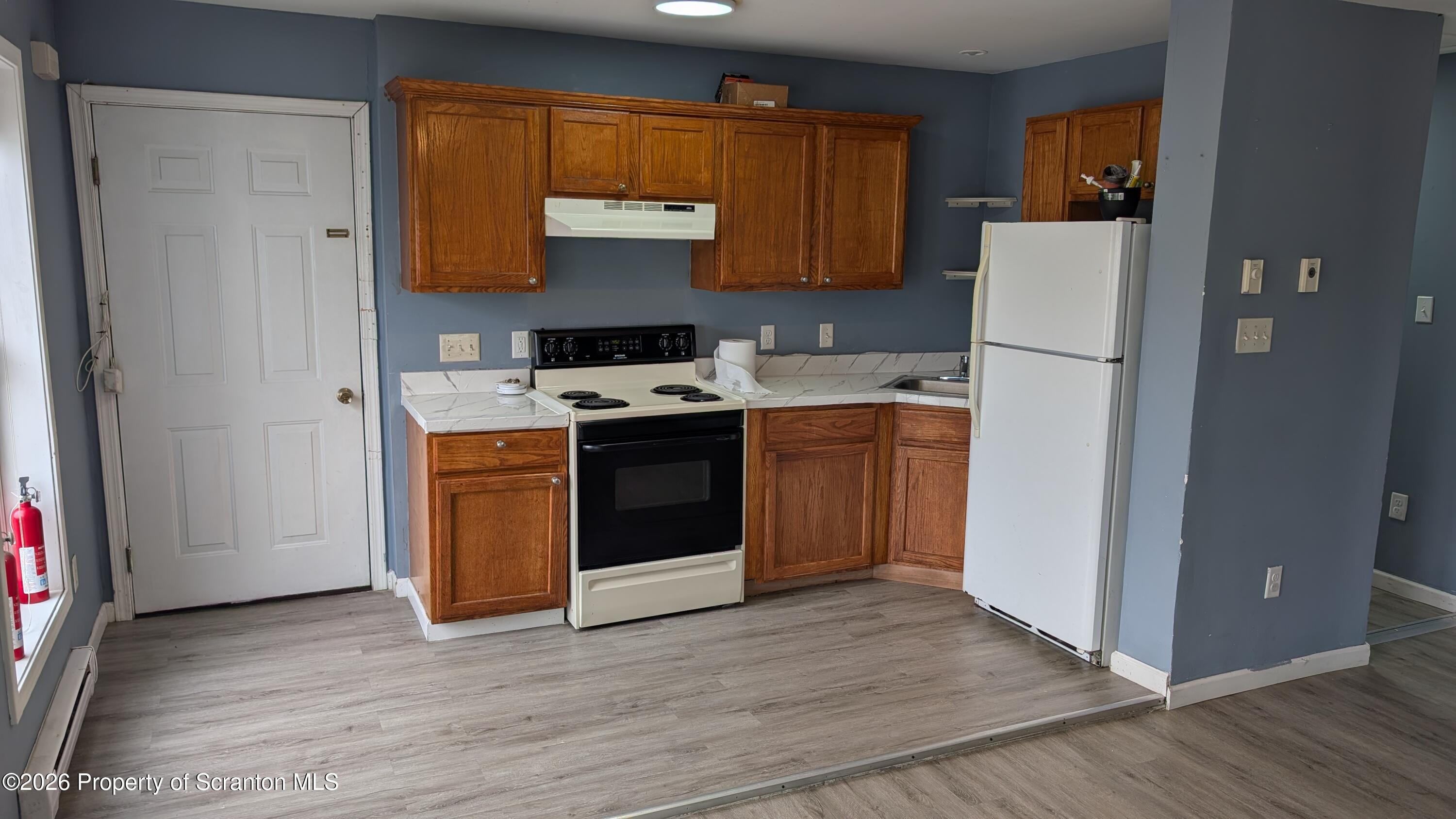 114 Prospect Avenue, Unit 4 Scranton, PA 18505 - Photo 2 of 16 a kitchen with a stove a refrigerator and a stove