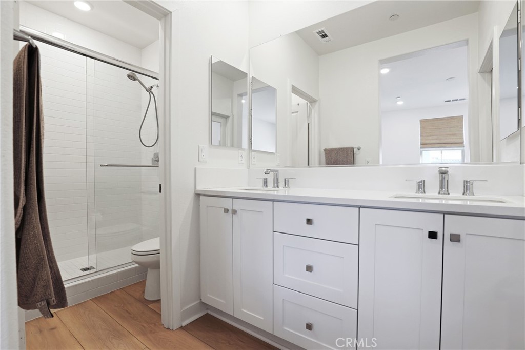 1300 Lasso Way, Unit 301 Rancho Mission Viejo, CA 92694 - Photo 12 of 17 a bathroom with a double vanity sink toilet and shower