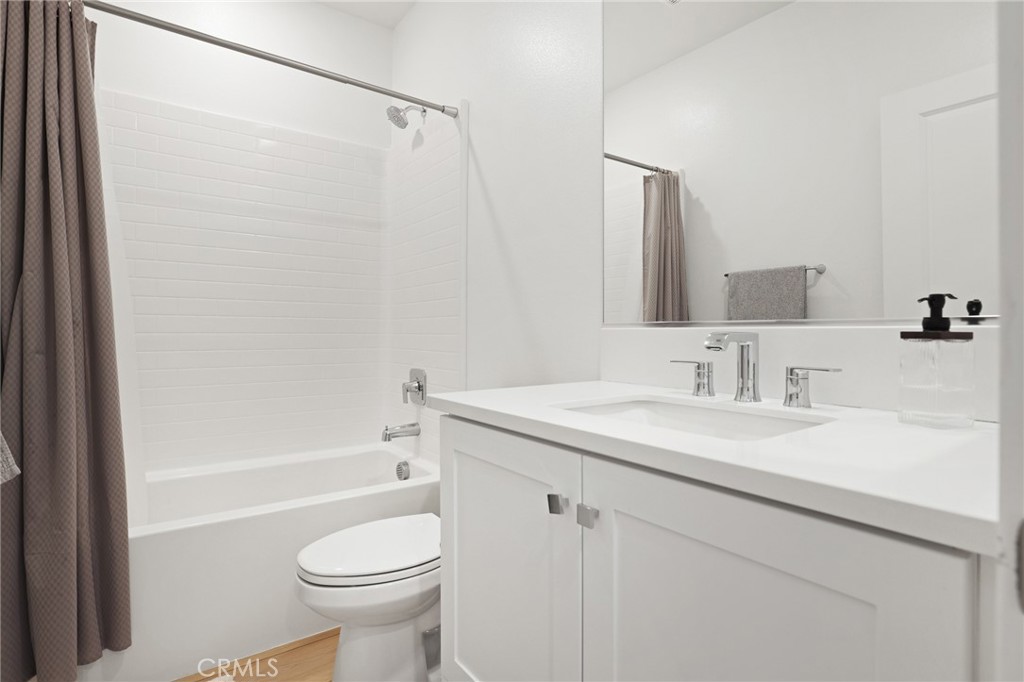1300 Lasso Way, Unit 301 Rancho Mission Viejo, CA 92694 - Photo 14 of 17 a bathroom with a sink a toilet and a bathtub