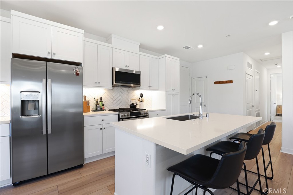 1300 Lasso Way, Unit 301 Rancho Mission Viejo, CA 92694 - Photo 3 of 17 a kitchen with a sink a refrigerator and a stove