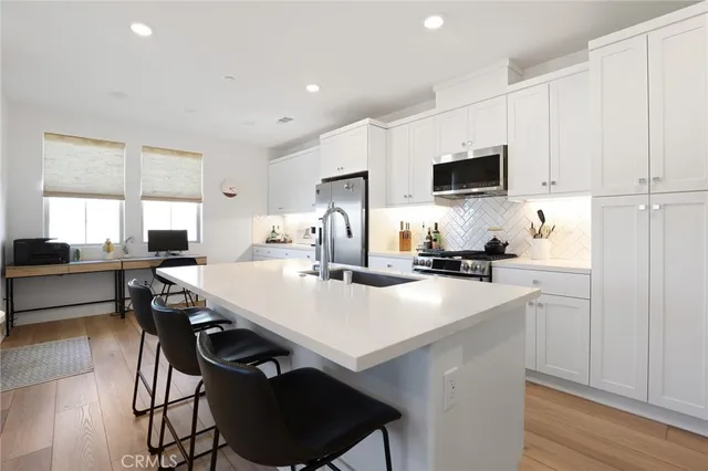 a kitchen with stainless steel appliances kitchen island granite countertop a sink and cabinets