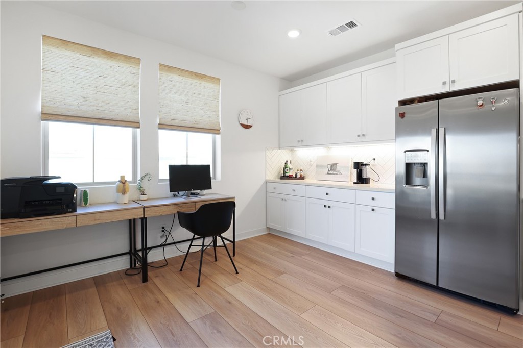1300 Lasso Way, Unit 301 Rancho Mission Viejo, CA 92694 - Photo 8 of 17 a kitchen with a sink cabinets and wooden floor