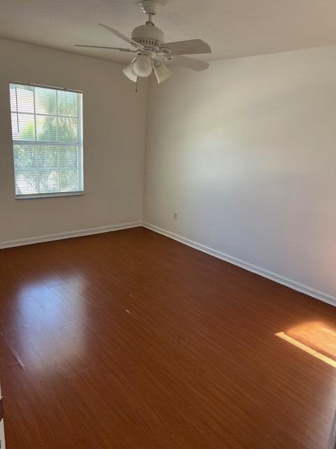 140 Baldwin Boulevard Greenacres, FL 33463 - Photo 11 of 18 an empty room with wooden floor fan and windows