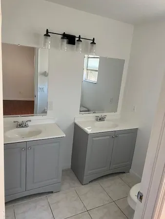 a utility room with a sink washer and dryer