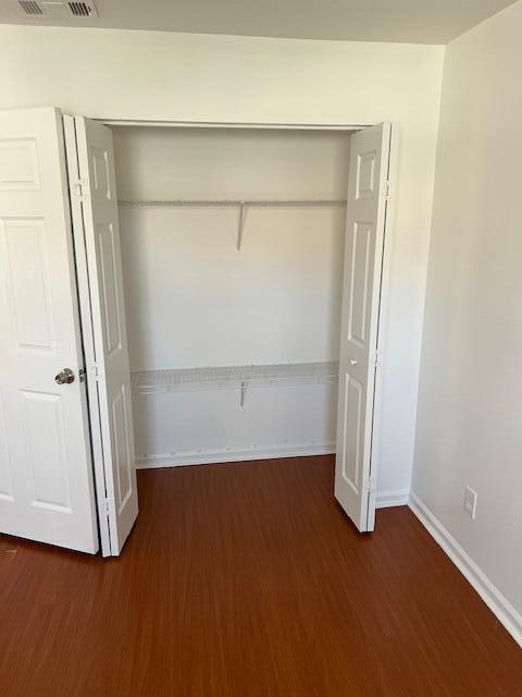 140 Baldwin Boulevard Greenacres, FL 33463 - Photo 16 of 18 an empty room with wooden floor and windows