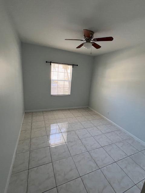 140 Baldwin Boulevard Greenacres, FL 33463 - Photo 8 of 18 an empty room with windows and fan