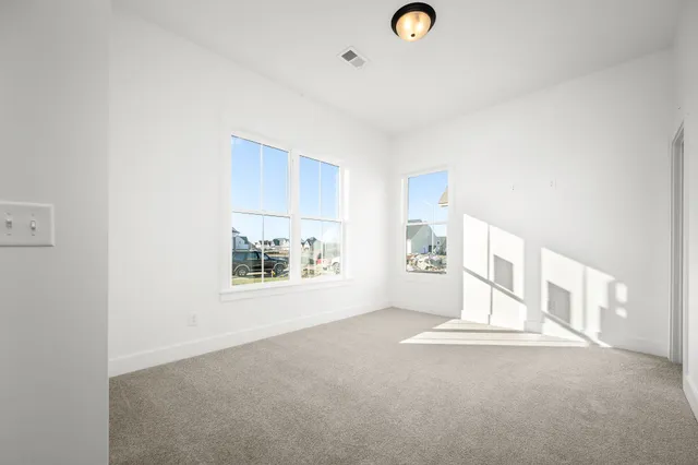 a view of a livingroom with wooden floor and a window
