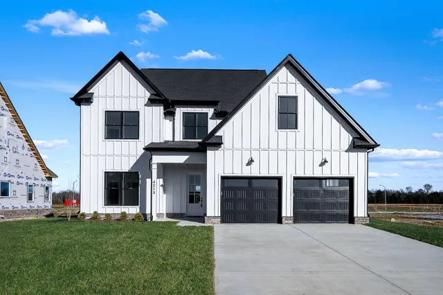 a front view of a house with a yard and garage