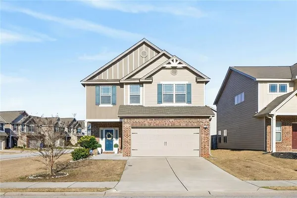 a front view of a house with a yard