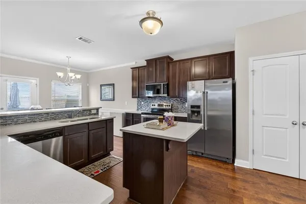 a kitchen with a sink and a stove top oven