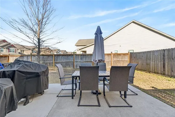 a view of a patio with a table and chairs