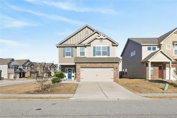 a front view of a house with a yard