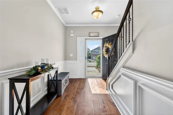 a view of entryway and hall with wooden floor