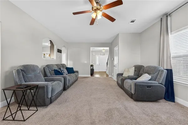 a living room with furniture wooden floor and a flat screen tv