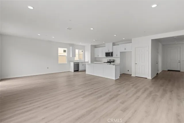 a view of a kitchen with a sink and a stove top oven