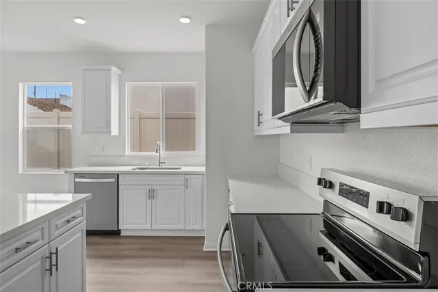 a kitchen with a sink stove and cabinets