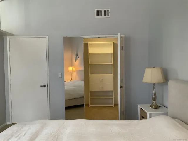a bedroom with a bed and a lamp on table