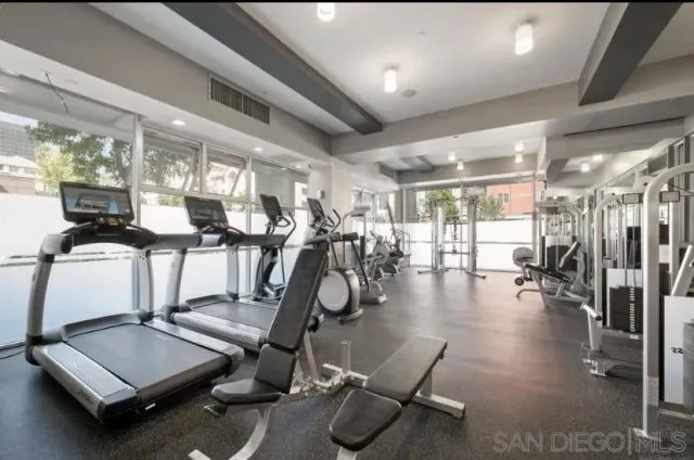 a room with gym equipment and windows
