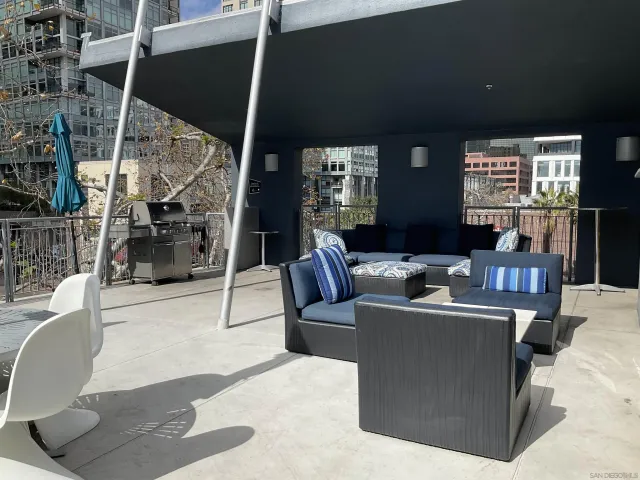 a living room with furniture a large window and potted plants