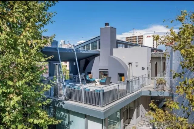 a view of a house with roof and sitting area