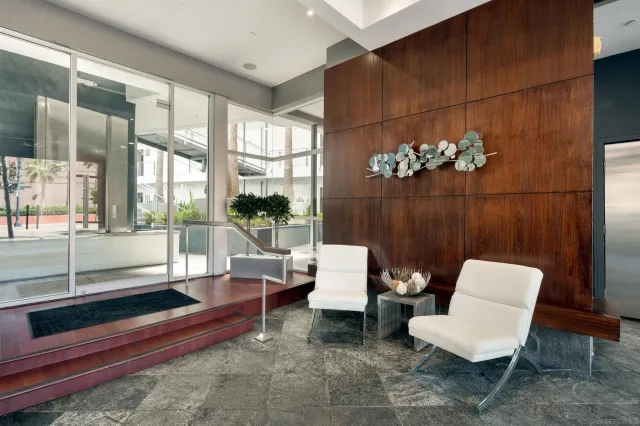 a living room with furniture and a floor to ceiling window