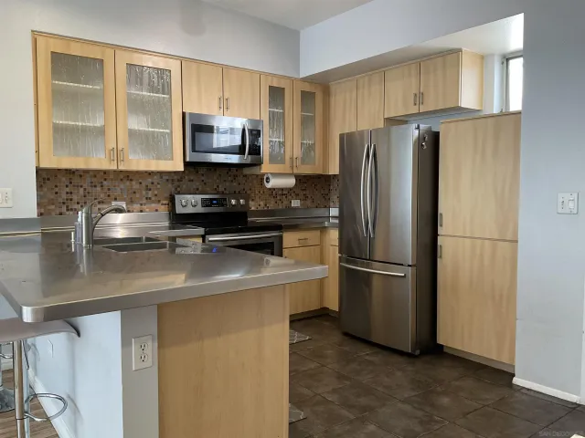 a kitchen with a refrigerator sink and microwave
