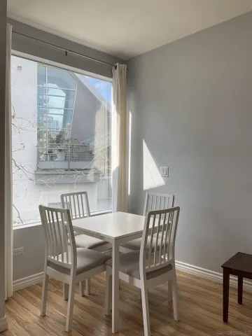 a dining room with furniture and wooden floor