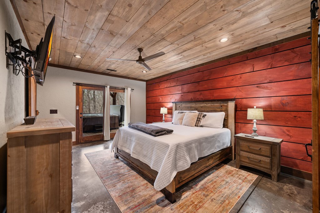134 Cohutta Overlook Trail Blue Ridge, GA 30513 - Photo 63 of 77 a bedroom with a bed and a chandelier