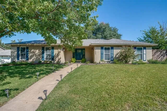 a view of a house with yard and a garden