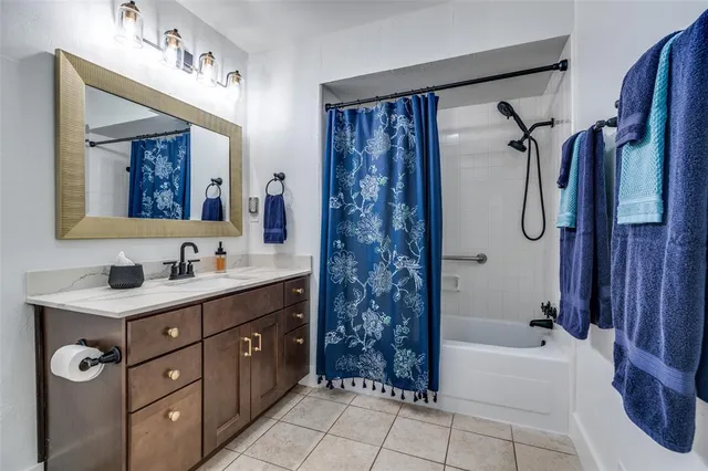 a bathroom with a tub sink and mirror